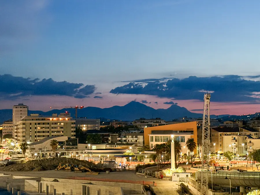 Le luci di Pescara al crepuscolo con la sagoma del Gran Sasso sullo sfondo